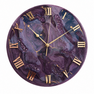 Elegant purple resin wall clock featuring a rich swirling violet design, gold veining, raised Roman numeral markers, and refined gold clock hands, displayed on a decorative stand in a luxurious interior setting