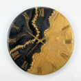 Luxury black and gold resin wall clock with Roman numerals and shimmering gold accents