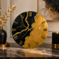 Elegant black and gold resin wall clock featuring a bold design and luxurious golden detailing.