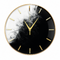 Elegant black-and-white minimalist resin wall clock with gold rim, hands, and markers in a luxury modern setting.