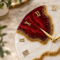 Close-up cherry red resin wall clock with gold details macro